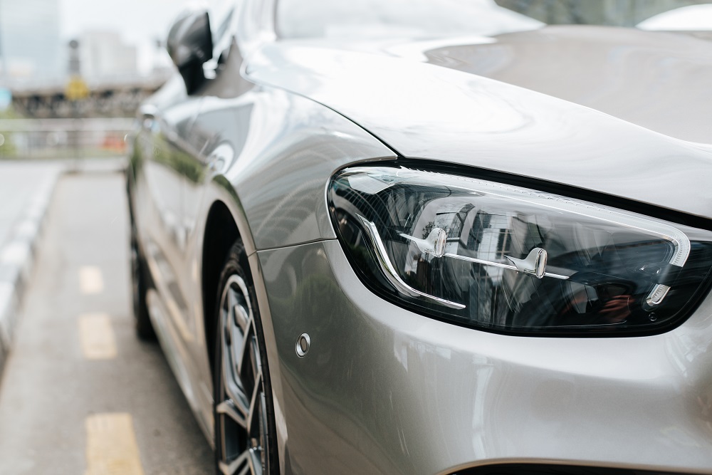 The front of a car protected by Ceramic Coating New Orleans shines brilliantly, showcasing a flawless finish and enhanced durability.